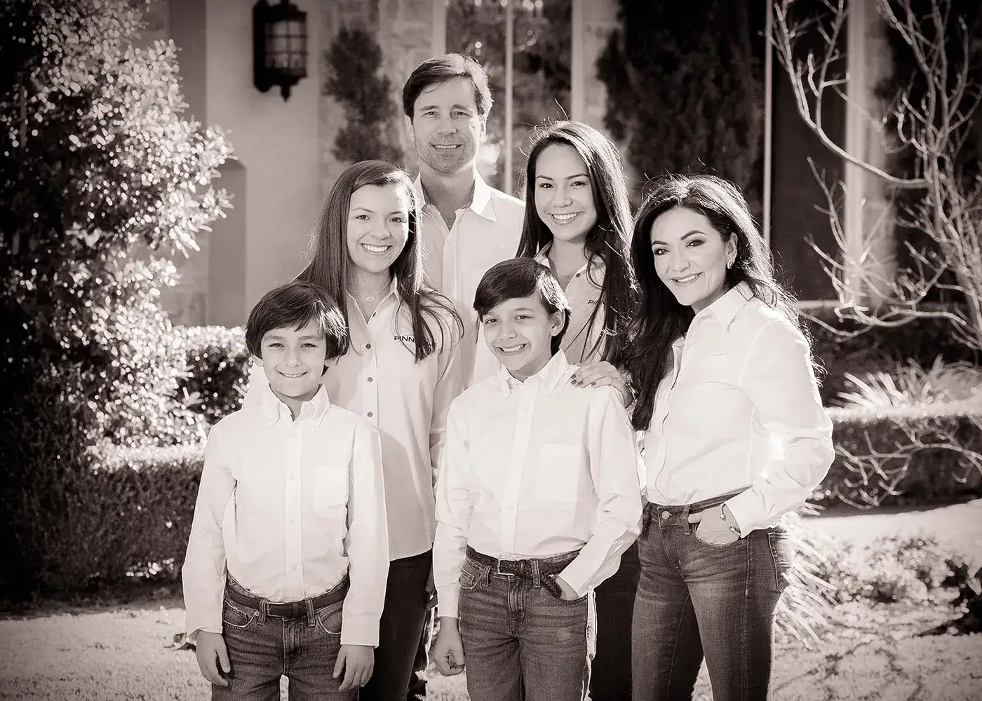 Black-and-white outdoor portrait of a family of six