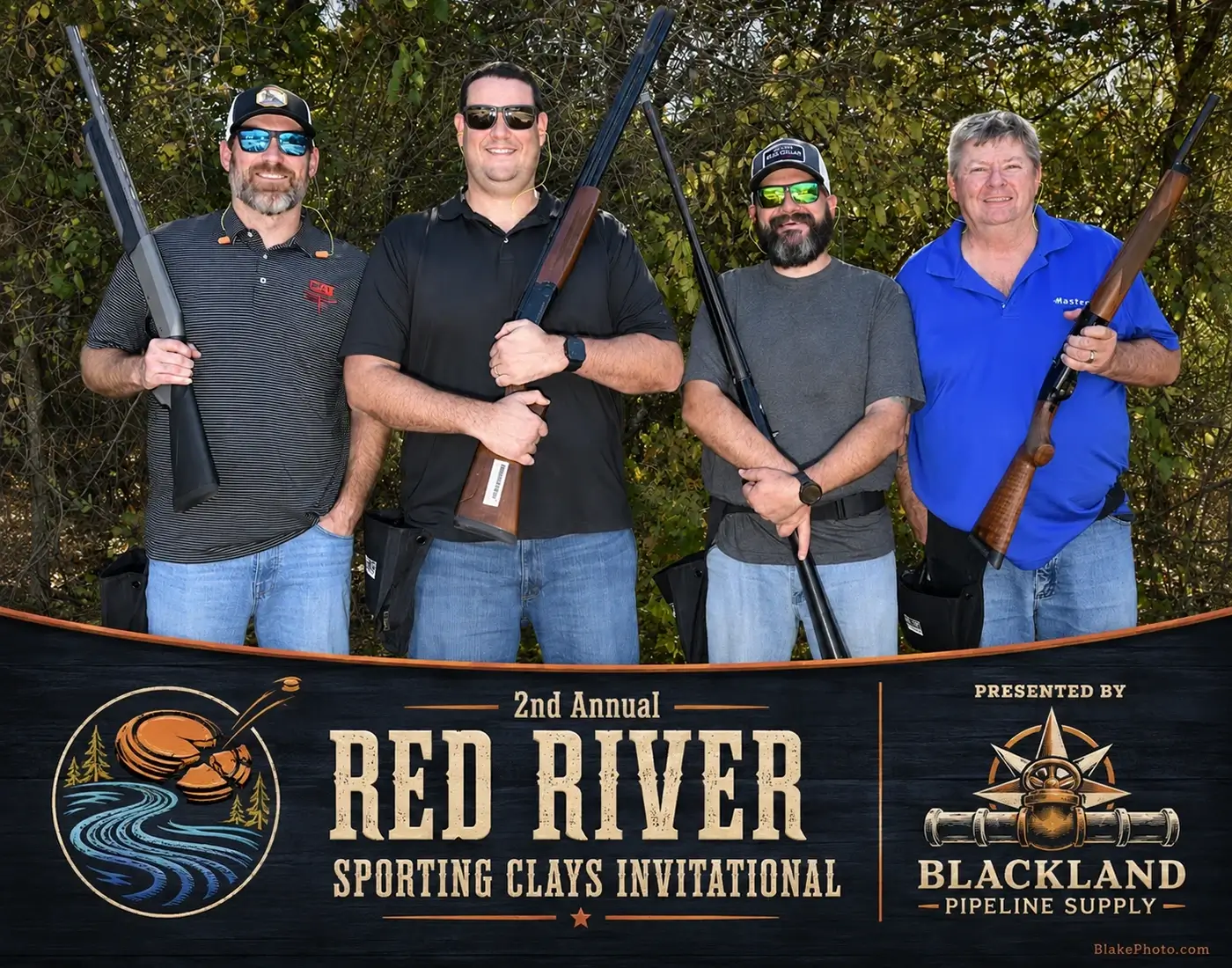 Clay shoot participants posing with shotguns for their finished team photograph.