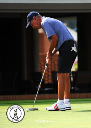 Golfer making final putt at golf tournament in Dallas-Ft Worth