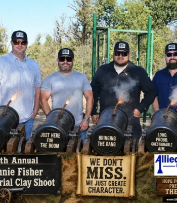 `Four clay shoot participants behind novelty cannons at the 9th Annual Ronnie Fisher Memorial Clay Shoot`
